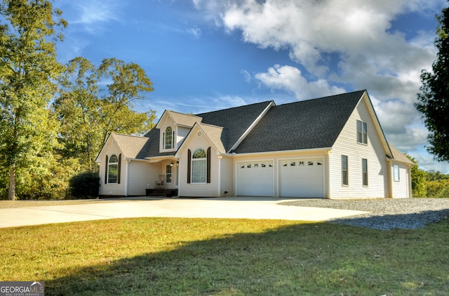 view of front of house featuring a garage and a front lawn