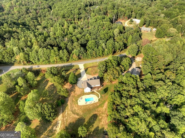 drone / aerial view featuring a view of trees