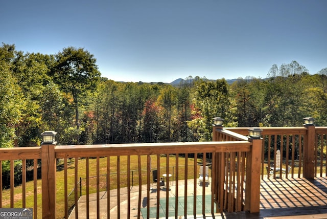 wooden deck featuring a view of trees