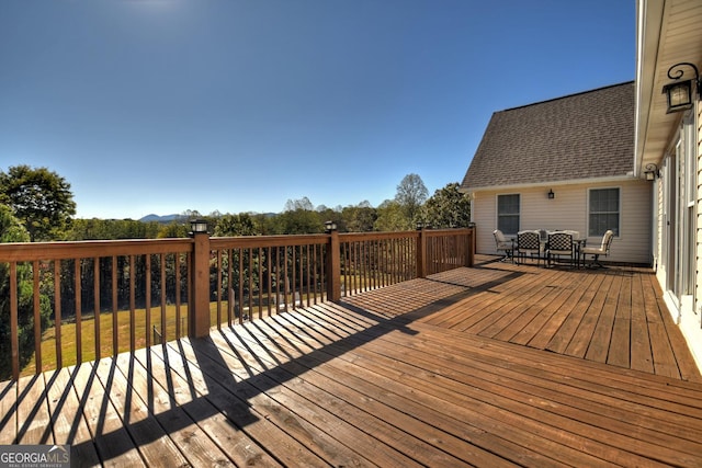 wooden deck with outdoor dining space