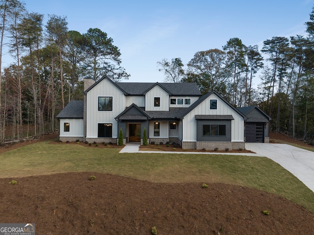 modern inspired farmhouse with a garage and a front yard