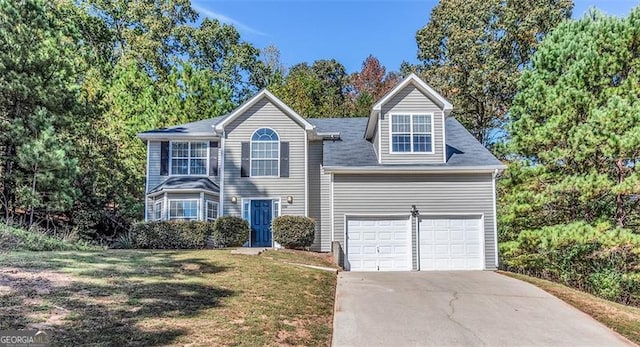 view of front of property with a garage and a front lawn