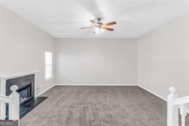 unfurnished living room featuring dark colored carpet and ceiling fan