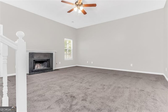 unfurnished living room featuring carpet and ceiling fan