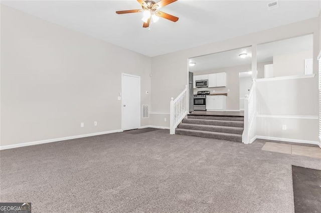 unfurnished living room featuring ceiling fan and carpet flooring