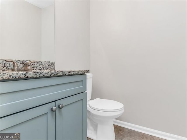 bathroom featuring tile patterned floors, vanity, and toilet