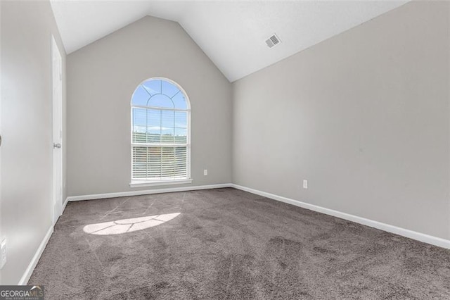 empty room featuring lofted ceiling and carpet flooring