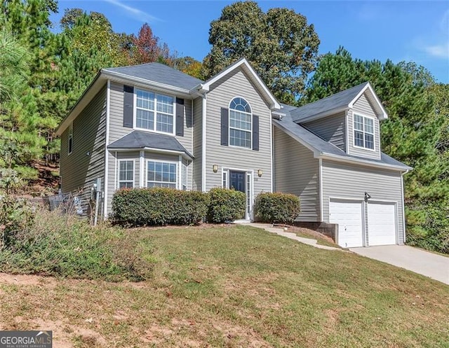 view of front of house with a garage and a front yard