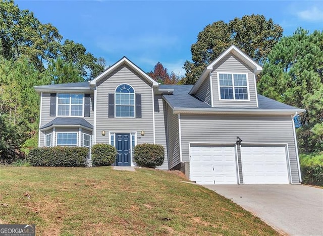 view of front of home with a front yard and a garage