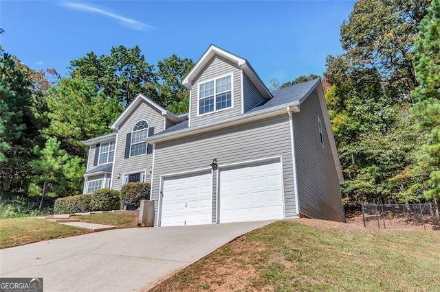 view of front of home with a front lawn and a garage