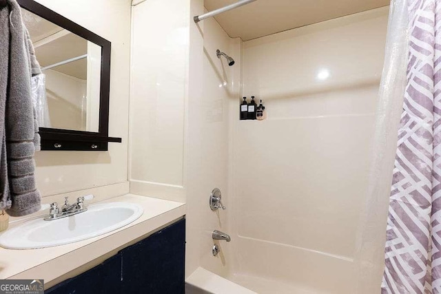 bathroom featuring vanity and shower / bath combination with curtain