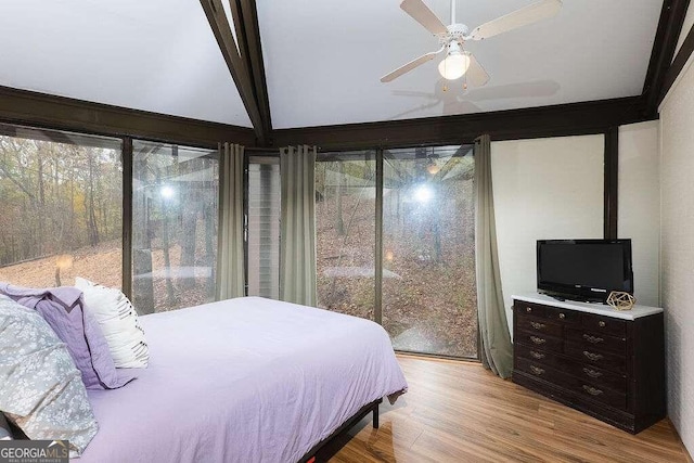 bedroom with beamed ceiling, ceiling fan, and light hardwood / wood-style flooring