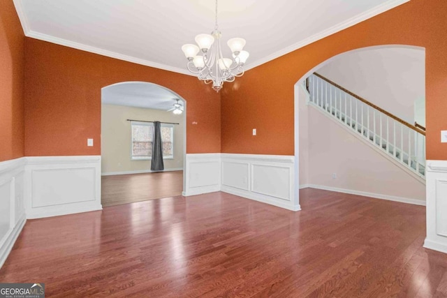 unfurnished room with hardwood / wood-style floors, ceiling fan with notable chandelier, and crown molding