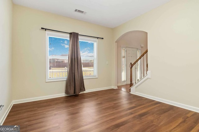 unfurnished room featuring dark hardwood / wood-style floors