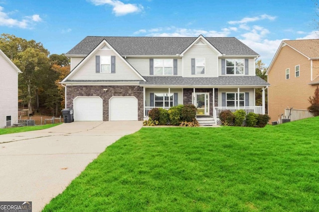 view of front of property featuring a garage, a front yard, and a porch