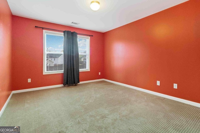 unfurnished room featuring carpet