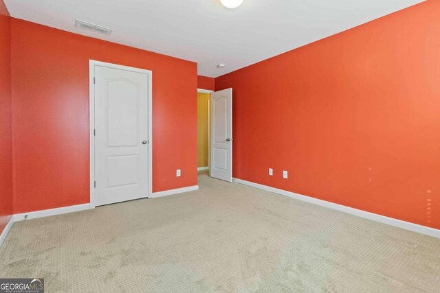 unfurnished bedroom with light colored carpet