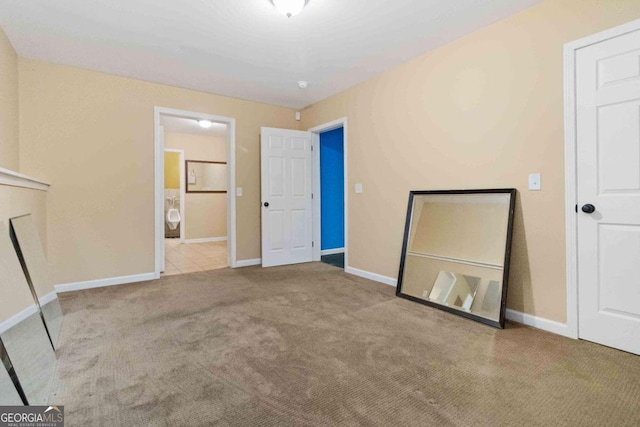 unfurnished room featuring light colored carpet