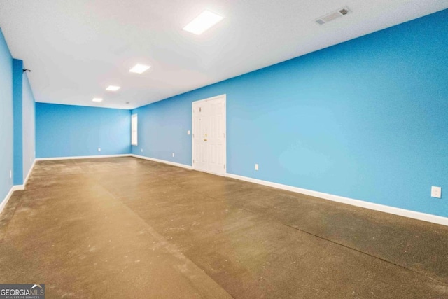 empty room with concrete flooring