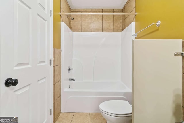 bathroom featuring  shower combination, tile patterned floors, and toilet