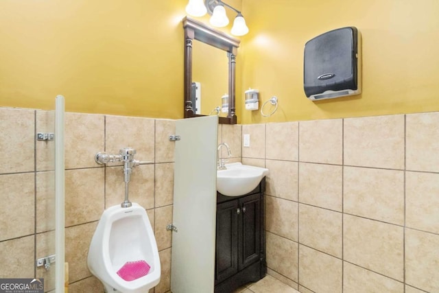 bathroom with tile walls and vanity