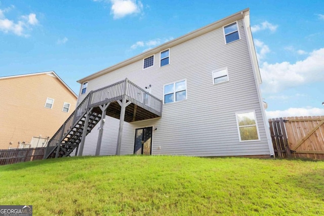 back of house with a lawn and a deck