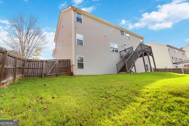 back of house with a yard and a wooden deck