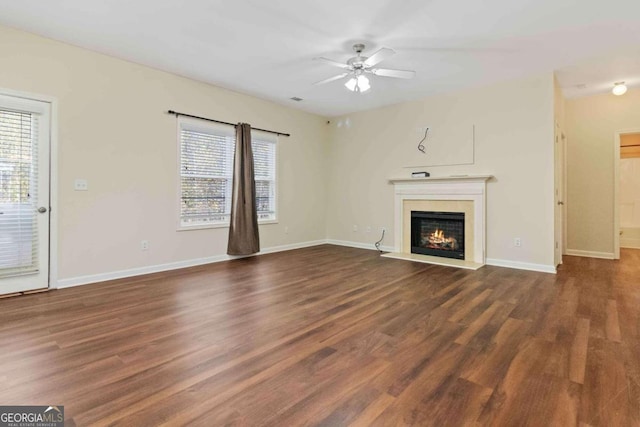 unfurnished living room with dark wood-type flooring and ceiling fan