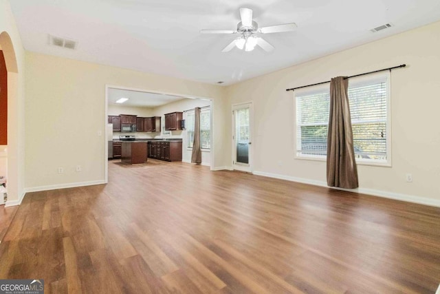 unfurnished living room with hardwood / wood-style floors and ceiling fan