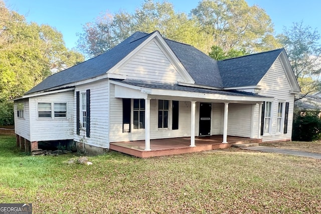 view of front of property with a front lawn and a wooden deck