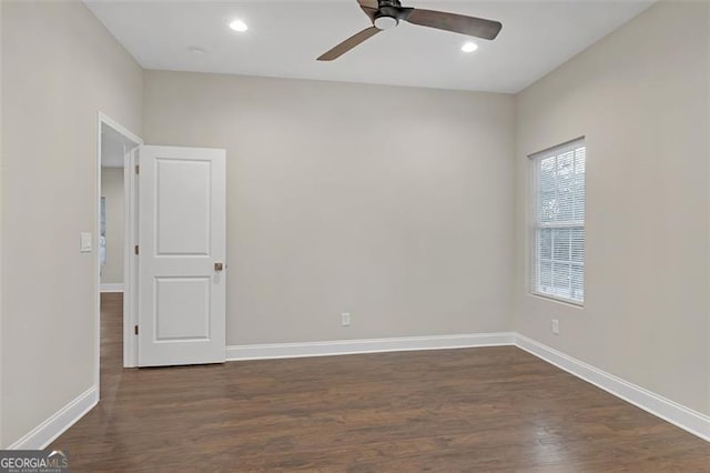 spare room featuring ceiling fan and dark hardwood / wood-style flooring