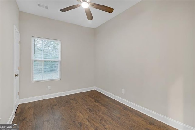 empty room featuring ceiling fan and dark hardwood / wood-style flooring