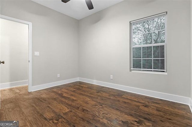 empty room with ceiling fan and dark wood-type flooring