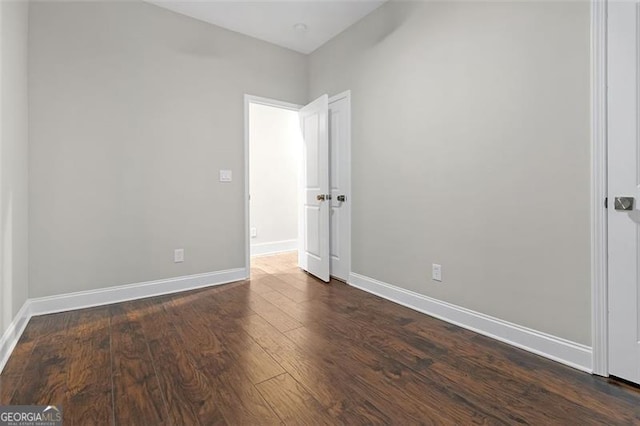 spare room featuring dark hardwood / wood-style floors