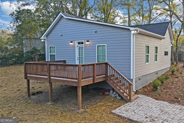 rear view of house with a wooden deck