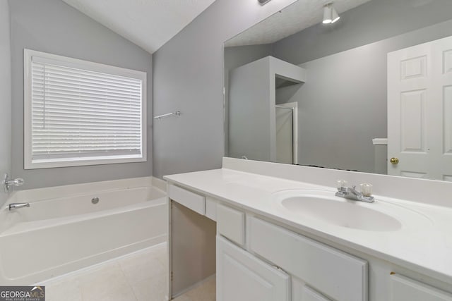 bathroom with a tub, tile patterned flooring, a textured ceiling, vanity, and lofted ceiling