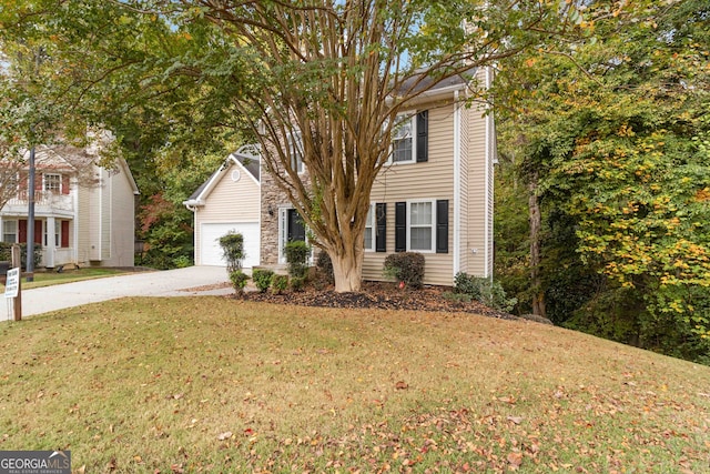 view of front of property featuring a garage and a front yard