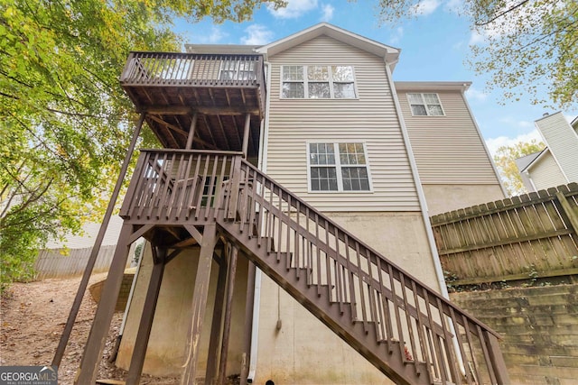 back of house with a wooden deck