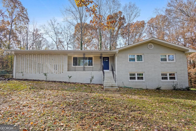 view of front of property with a porch and a front lawn