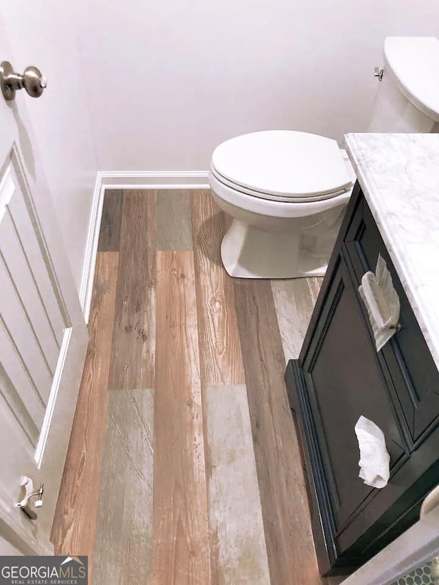 bathroom with vanity, hardwood / wood-style floors, and toilet