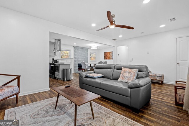 living room featuring dark hardwood / wood-style flooring and ceiling fan