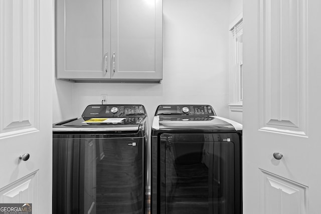 laundry area featuring cabinets and washer and dryer