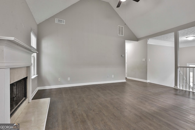 unfurnished living room with a textured ceiling, high vaulted ceiling, dark hardwood / wood-style floors, and ceiling fan