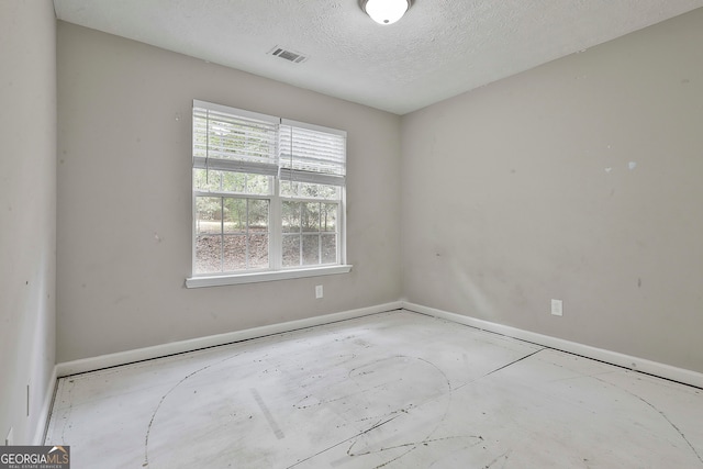 unfurnished room featuring a textured ceiling and a healthy amount of sunlight