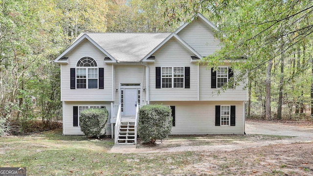 raised ranch with a front yard