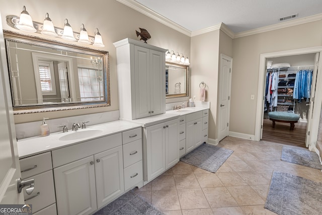 bathroom featuring ornamental molding, tile patterned flooring, and vanity