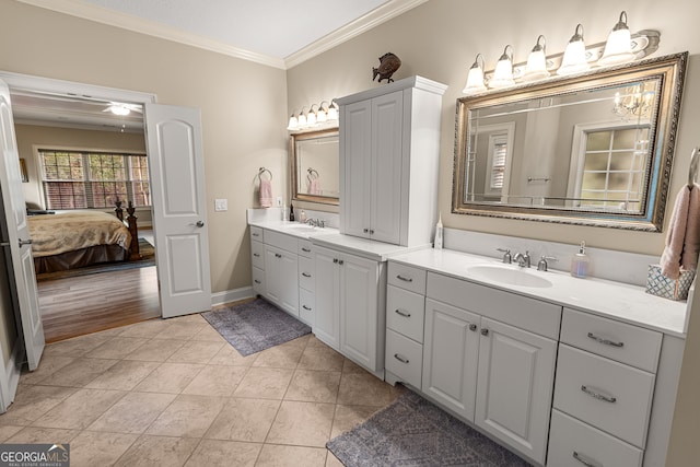 bathroom featuring ornamental molding, hardwood / wood-style floors, vanity, and ceiling fan