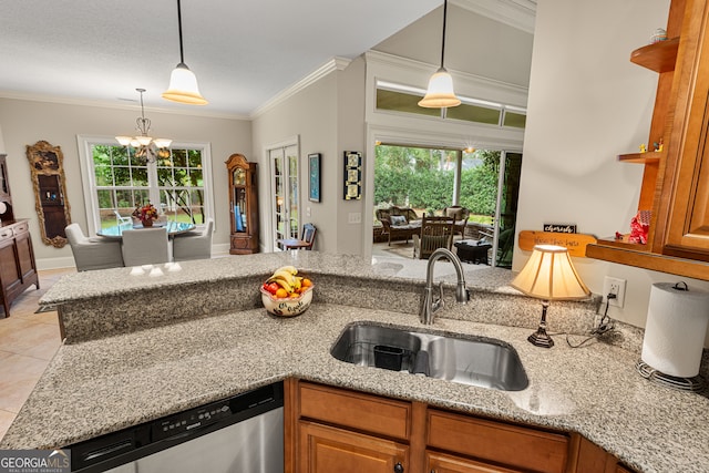 kitchen with dishwasher, sink, light stone counters, and plenty of natural light