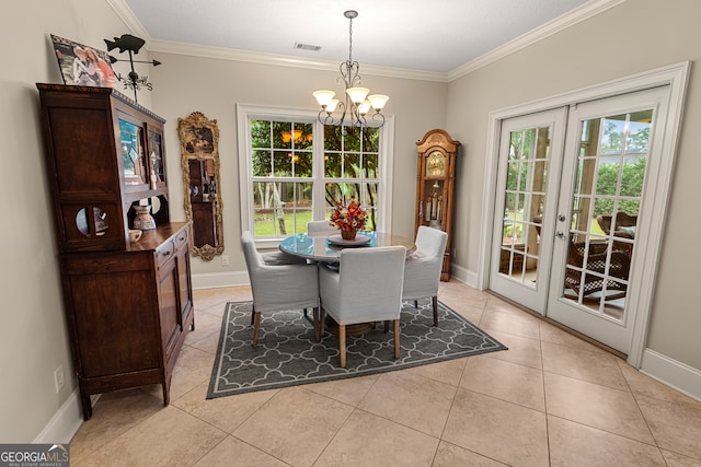 tiled dining space featuring ornamental molding, french doors, a healthy amount of sunlight, and an inviting chandelier