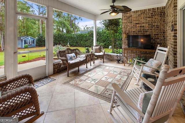 sunroom featuring plenty of natural light and ceiling fan